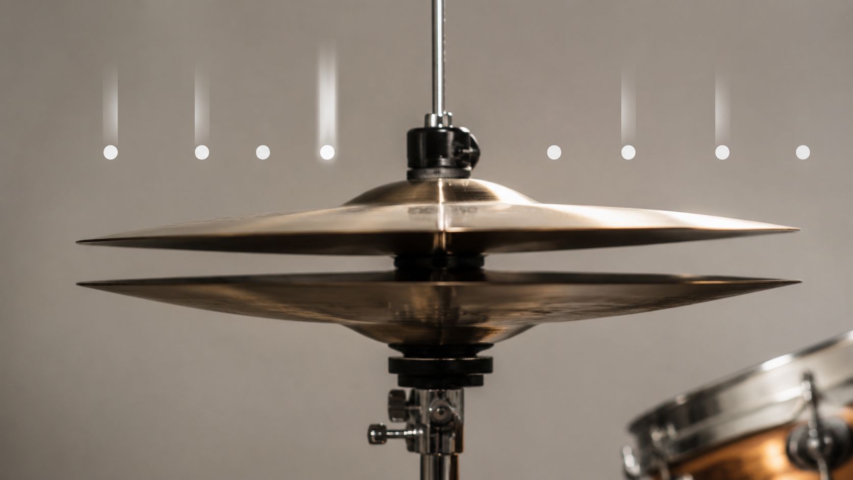 Close up shot of hi-hat cymbals on a drum kit with glowing rhythmic pattern lines above them